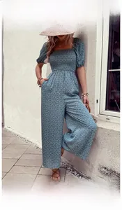 Detail of blue floral jumpsuit featuring square neck and puff sleeves for summer style