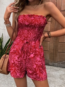 Floral off-shoulder smocked romper with vibrant palm leaf print for summer beach vacations