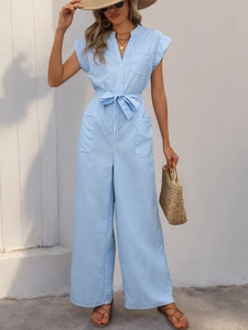 Detailed view of light blue striped jumpsuit with waist tie and buttons for summer