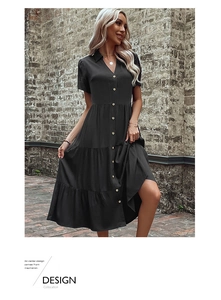 Detail of black tiered shirt dress with gold buttons and breathable cotton texture