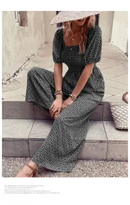 Detail of square neck floral romper with puff sleeves and wide-leg cut for summer