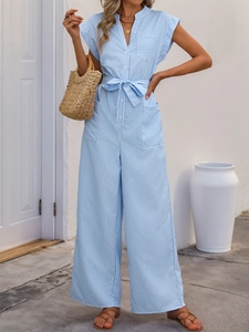 Close-up of the V-neckline and button detail on a blue and white striped summer jumpsuit