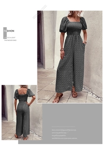 Detail view showing black floral romper with square neck, puff sleeves and smocked waist