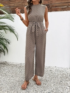 Detail of sleeveless geometric print jumpsuit with waist tie and loose wide legs