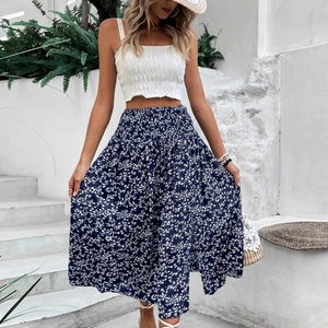 Women's summer two-piece outfit featuring white smocked crop top and navy floral maxi skirt
