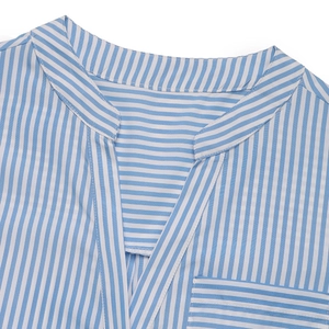 Detail of V-neck and stand collar on blue and white vertical striped jumpsuit