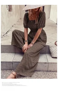 Macro detail of retro floral print on square neck jumpsuit with puff sleeves design