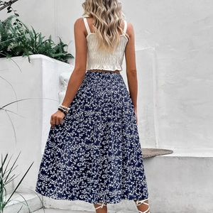 Women's summer vacation set with white pleated tank top and navy blue floral midi skirt
