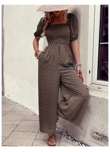 Detailed view of floral olive green romper with puff sleeves and elastic waist
