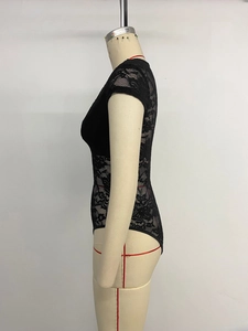 Detail view of the floral lace texture and side cut of this black V-neck bodysuit