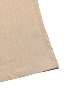 Close-up of beige wide-leg trousers showing vertical stripe texture and precise stitching