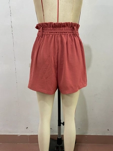 Detail view of high waist elastic paperbag waistband on dusty pink summer shorts