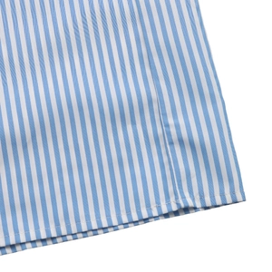 Detailed close-up of blue and white vertical striped fabric with neat flat seam hem