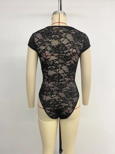 Detail view of the back of a black lace bodysuit featuring floral patterns and sheer mesh