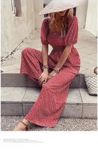 Close-up of red floral romper featuring a square neckline and smocked waist design