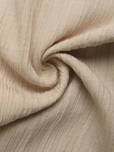 Macro shot of the vertical pleated texture on these champagne high waist wide leg pants