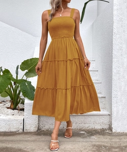 Detail of ginger yellow midi dress with smocked bodice and tiered ruffle skirt