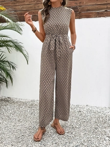 Detail of sleeveless geometric print jumpsuit with waist tie and wide leg trousers