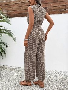 Detail of backless sleeveless jumpsuit featuring black geometric chain print on beige fabric