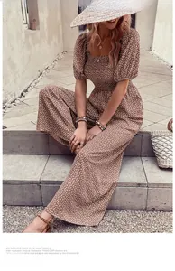 Detail of floral smocked waist and puff sleeves on a brown summer jumpsuit