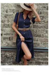 Close-up of navy blue shirt dress featuring a V-neckline with buttons and straw belt