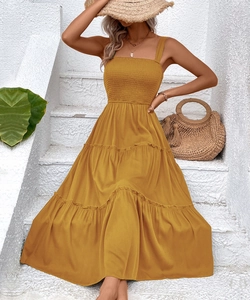 Detail of smocked sleeveless tiered summer dress in ginger yellow for vacation look