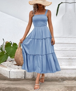 Detail of blue smocked bodice and tiered hemline on summer bohemian sun dress