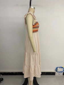 Detail of summer strap dress featuring ethnic embroidery and tiered ruffle skirt