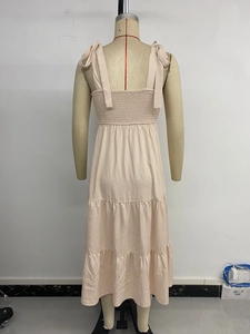 Rear view of tiered summer dress featuring smocked back and adjustable shoulder ties