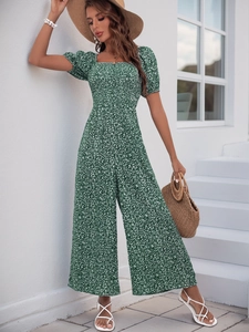 Detail of square neck and puff sleeves on a green floral print wide-leg jumpsuit