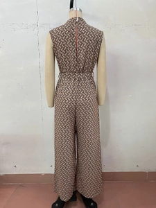 Rear view of sleeveless jumpsuit featuring geometric chain print and adjustable waist tie