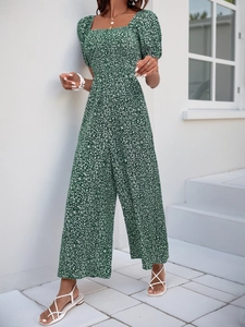 Detail of dark green floral wide-leg jumpsuit with square neck and puff sleeves