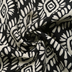 Macro detail of high-quality black and white geometric tribal print fabric for jumpsuit