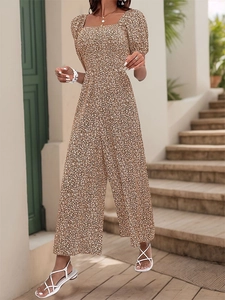 Detailed view of the square neckline and vintage puff sleeves on the floral romper