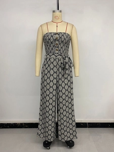 Detail of strapless geometric jumpsuit with halter tie, wood buttons and belted waist