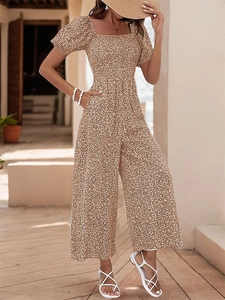Detail of the high waist cut and side pockets on a floral print wide-leg jumpsuit