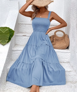 Detail of smocked bodice and tiered ruffle hem on this blue summer vacation dress