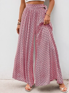 Detail of high-waisted wide-leg trousers with pink and purple retro geometric patterns