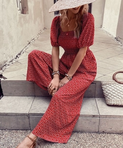 Detail of red floral romper featuring French square neck and puffed sleeves for summer
