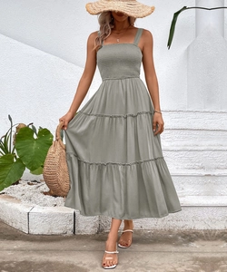 Detail of grey-green tiered summer dress featuring a shirred bodice and square neckline