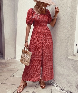 Detail of red floral romper featuring puff sleeves and elastic high-waisted smocked design