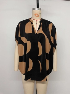 Close-up of V-neck loose blouse featuring abstract geometric print in black and brown
