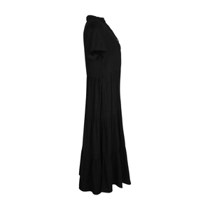 Side view of a tiered black maxi dress with short sleeves and a layered cake skirt design