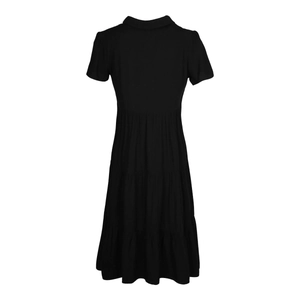 Detail view of the tiered cake-style skirt on a black short-sleeved collared midi dress