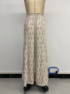 Floral print high-waisted wide-leg casual holiday pants for women on a mannequin