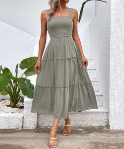 Detailed smocking on square neck bodice and tiered skirt of sage green maxi dress