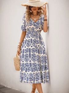 Detail of V-neck bohemian print dress with drawstring waist and puffed sleeves