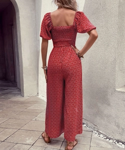 Detail of smocking elastic back on a red floral short sleeve wide-leg jumpsuit