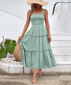 Close-up of sage green tiered midi dress with square neck and elastic smocked bodice