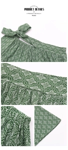 Detailed close-up of dark green geometric print fabric with lace-up waist and pleated texture